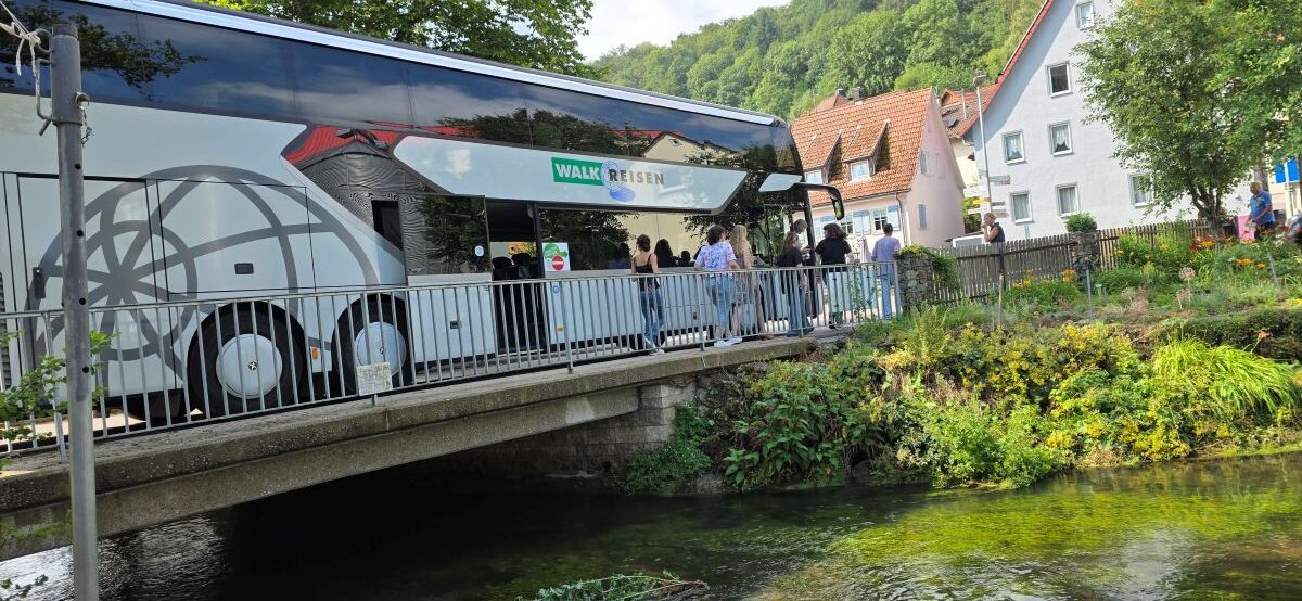 Group tour bus arriving in Buttenhausen for an educational outing.